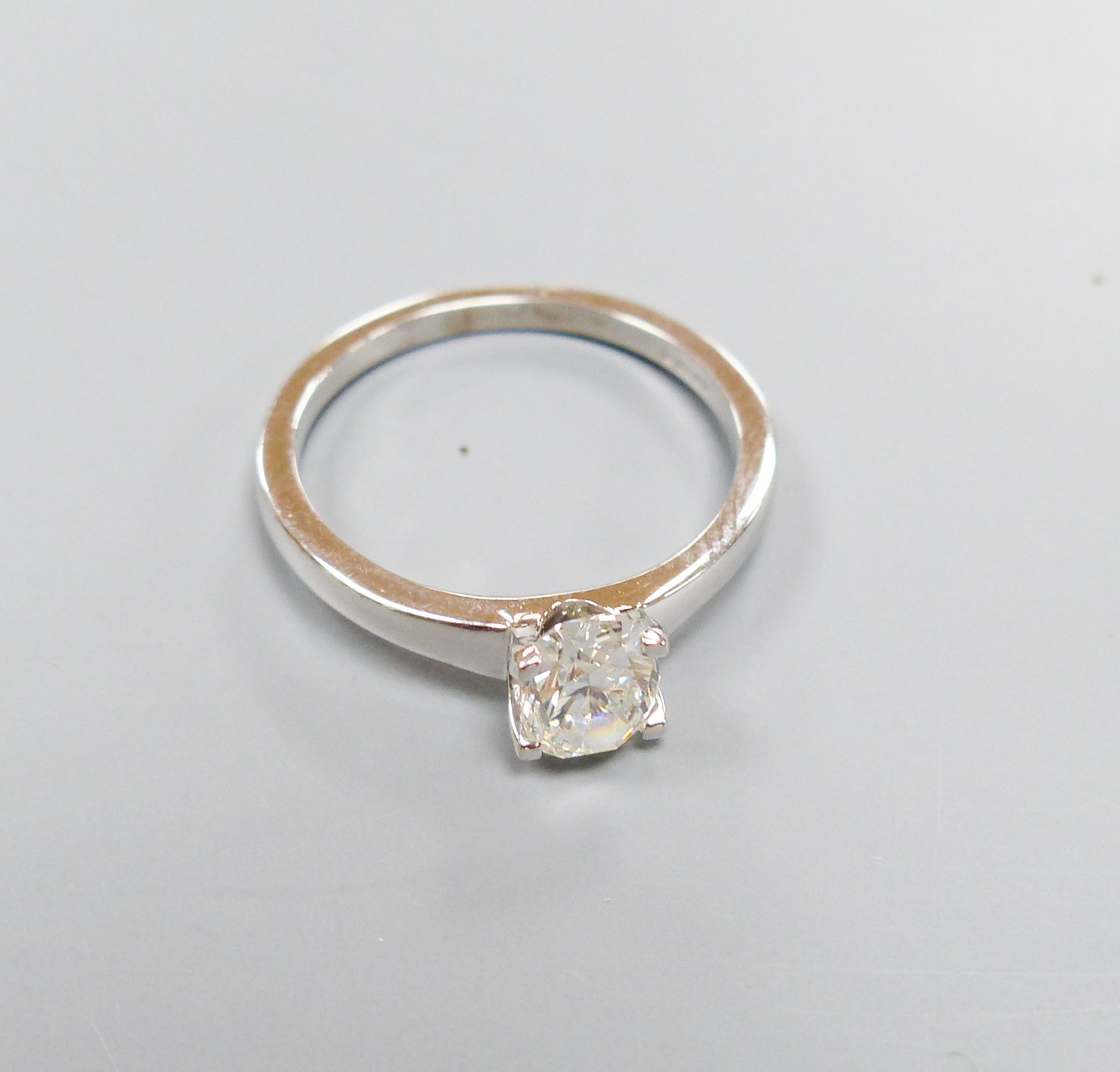 A modern 18ct white gold and solitaire oval cut diamond ring, size M, gross 3.1 grams, with GIA report dated 26/01/1999 stating the stone to weigh 0.88ct with a colour and clarity of F and SI1.